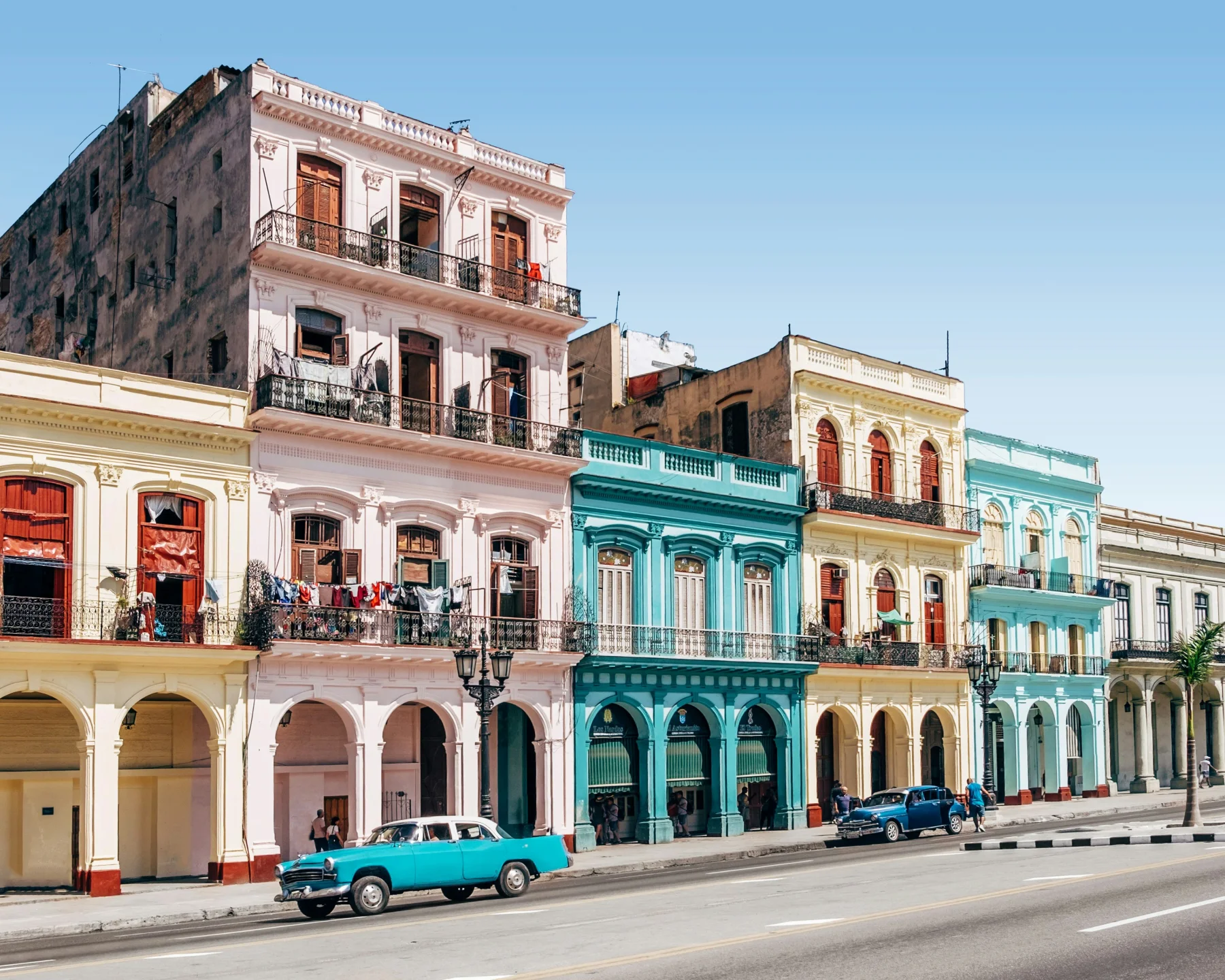 Colorful historic houses and cars on a street in Havana