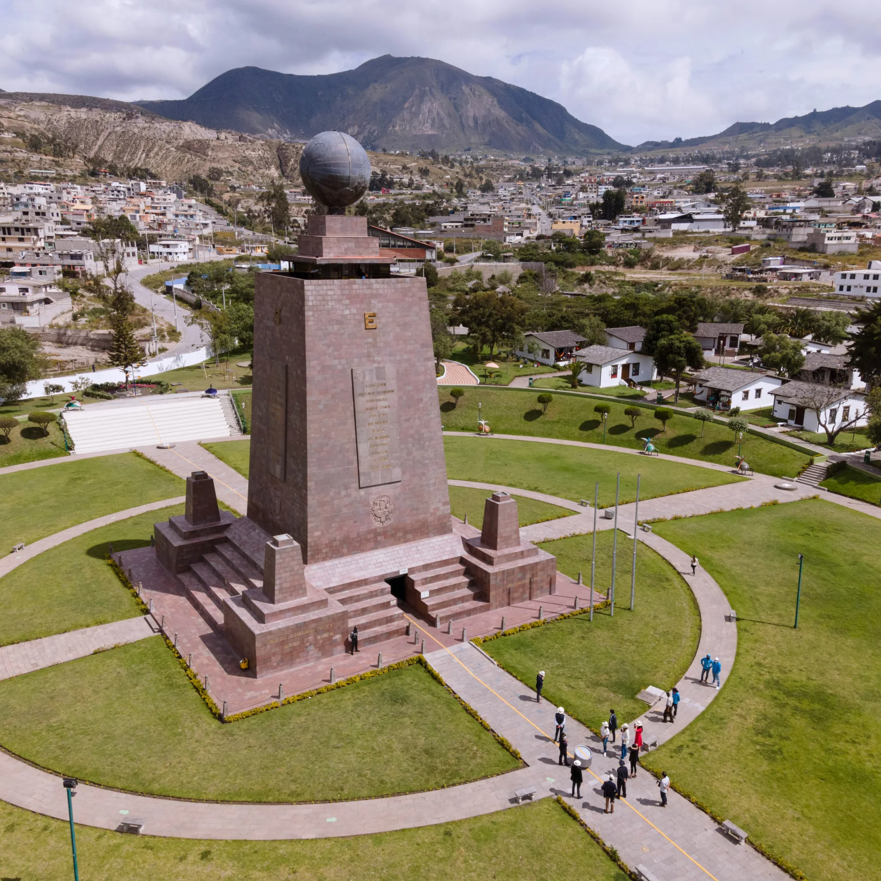 The Mitad del Mundo monument with mountains near Quito